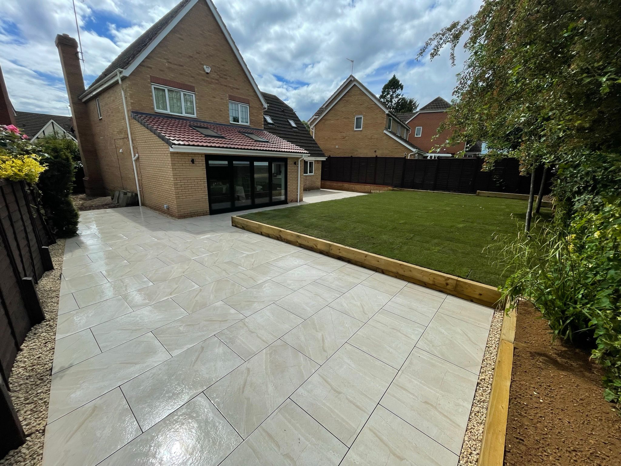 Landscaped garden with porcelain patio and lawn